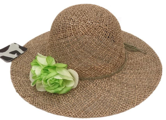 Wide-brimmed woven straw hat with a green flower accent, styled as a modest summer accessory for sun protection and graceful seasonal transitions by Tela Designs Store.
