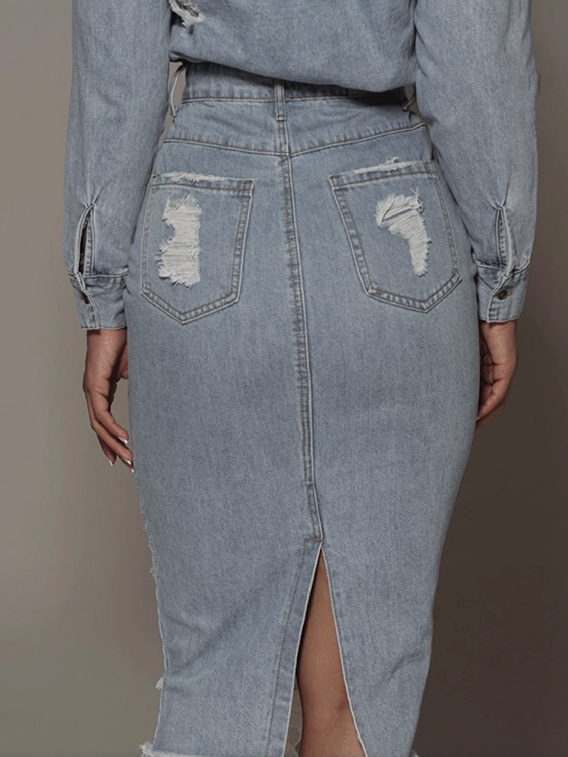 Back view of light wash denim midi skirt with distressed pockets and center slit, modest and modern style by Tela Designs Store