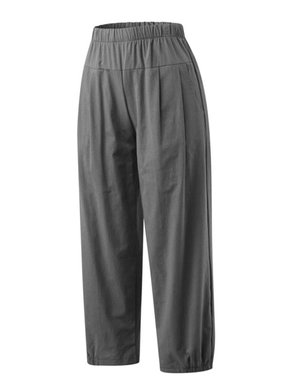 Sideways view highlighting the loose drape and cropped ankle-length hem of the grey cotton-linen pants with pockets at Tela Designs Store.