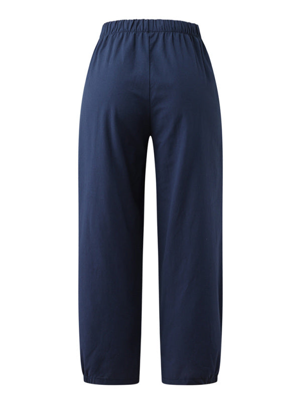 Displaying rear fit and flowy structure of the breathable black cotton-linen pants at Tela Designs Store.