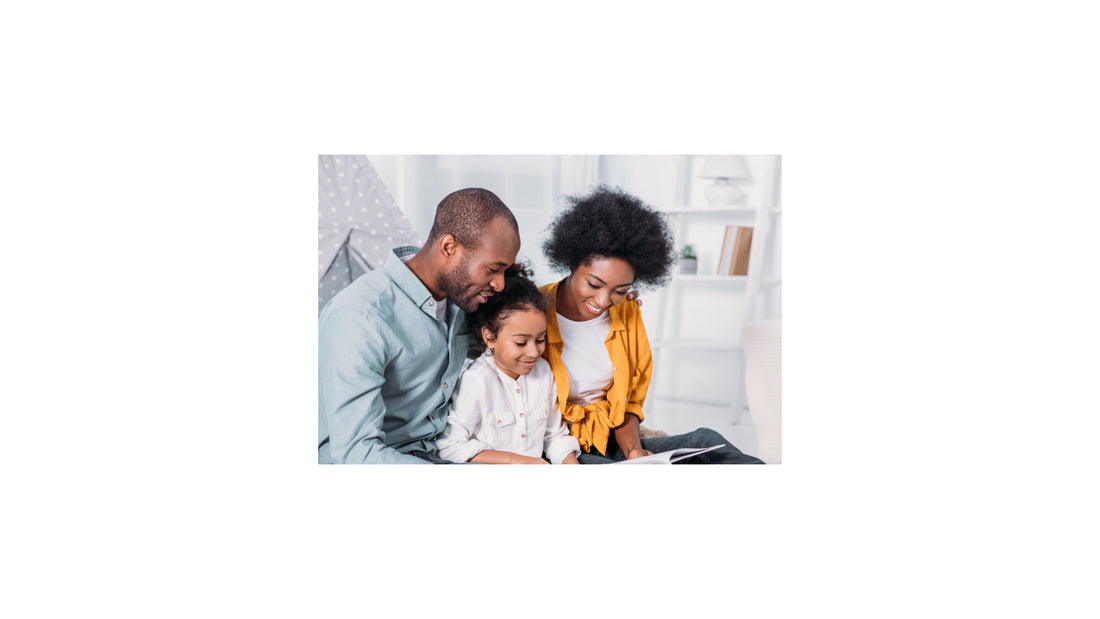 African american parents reading with daughter at home.