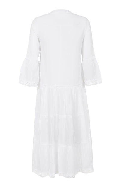 Back view flat-lay of white cotton modest dress with tiered layers highlighting the modest tie-back detail and lightweight fabric at Tela Designs Store.