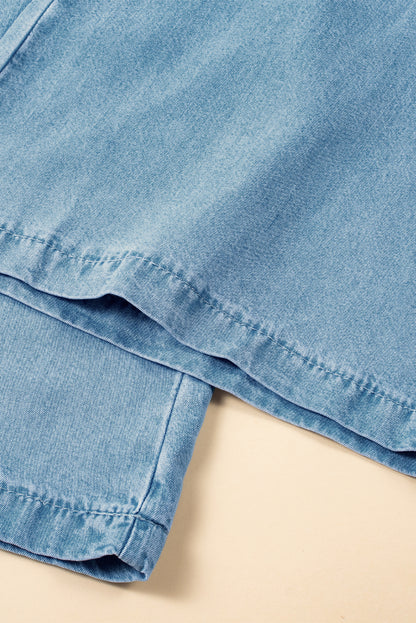 Flatlay of light blue wide-leg denim pants with double-stitched hem detail on beige background at Tela Designs Store