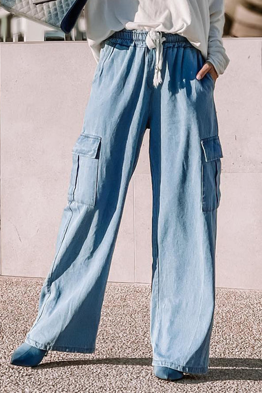 Lifestyle photo showcasing elastic waistband and relaxed fit of modest cotton chambray cargo pants in sunlight by Tela Designs Store