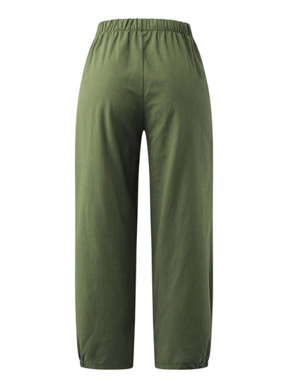 Displaying rear fit and flowy structure of the breathable sage green cotton-linen pants at Tela Designs Store.