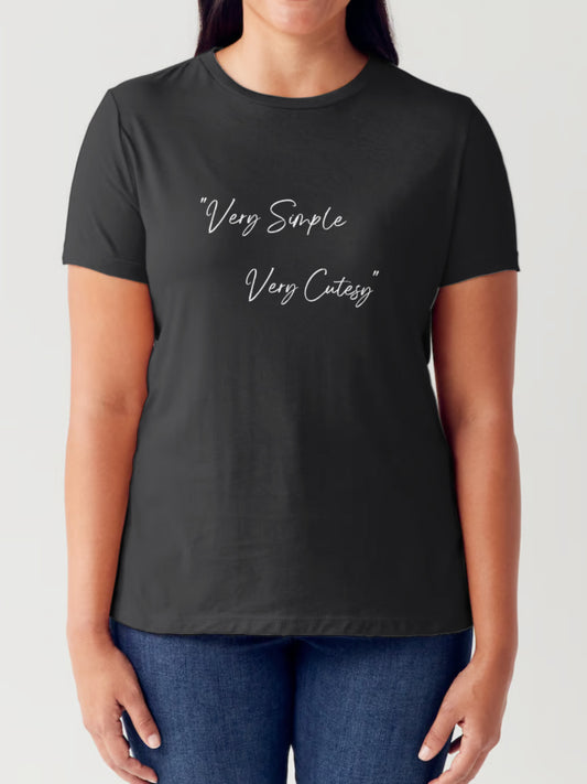 Image of a woman from neck to waist wearing the Unapologetic 'Very Simple Very Cutesy' graphic t-shirt with jeans, arms at her sides displaying the text on the shirt.